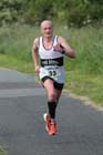 Steve Cairns (Tne Bridge) finishing the Tynedale 10k Road Race.